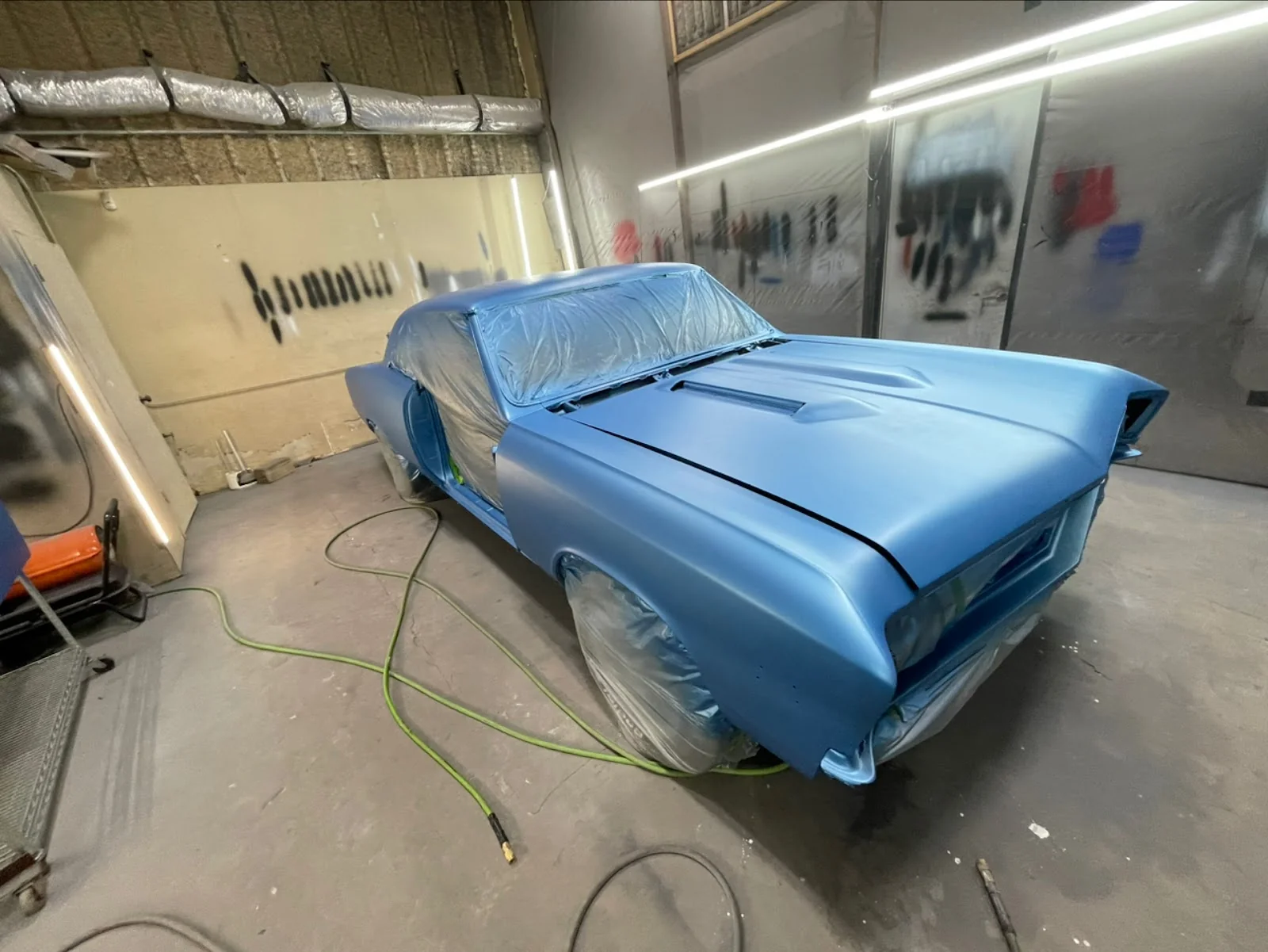 Mustang in the paint booth at Correct It Collision